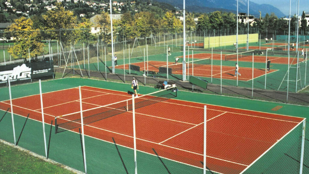 Red and Green Tennis Courts with Fencing and Lightning
