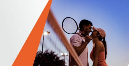 Male and Female Tennis Player Standing Next to Each Other Over the Net