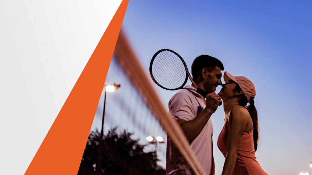 Male and Female Tennis Player Standing Next to Each Other Over the Net