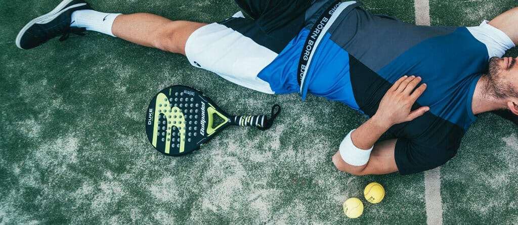 Padel Player Lays on the Artificial Grass