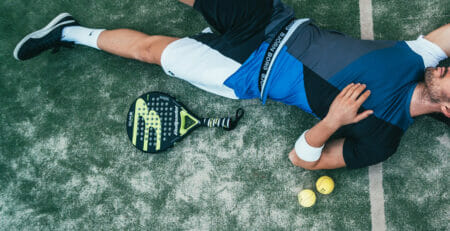 Padel Player Lays on the Artificial Grass