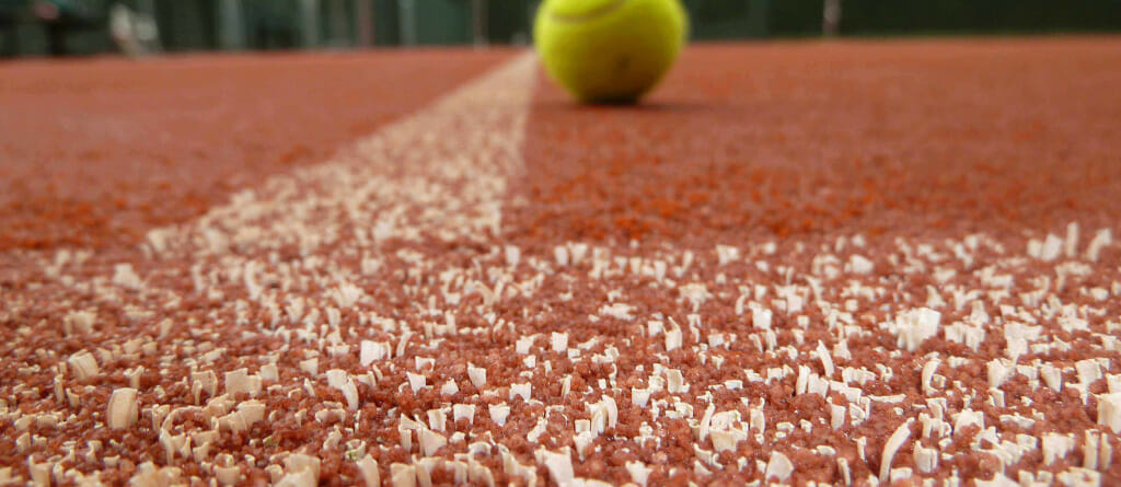 Tennis ball on Advantage Red Court surface
