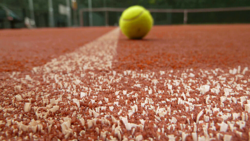 Tennis ball on Advantage Red Court surface